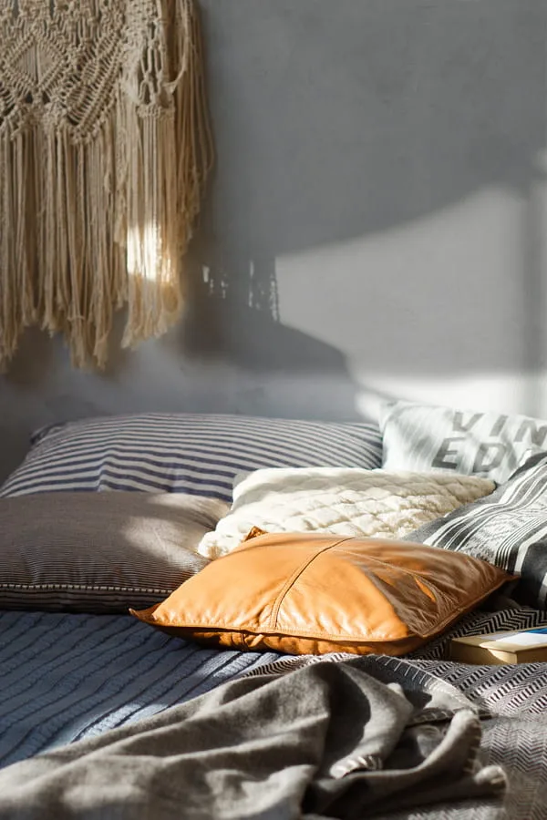 Bedroom decorated with cushions of different sizes