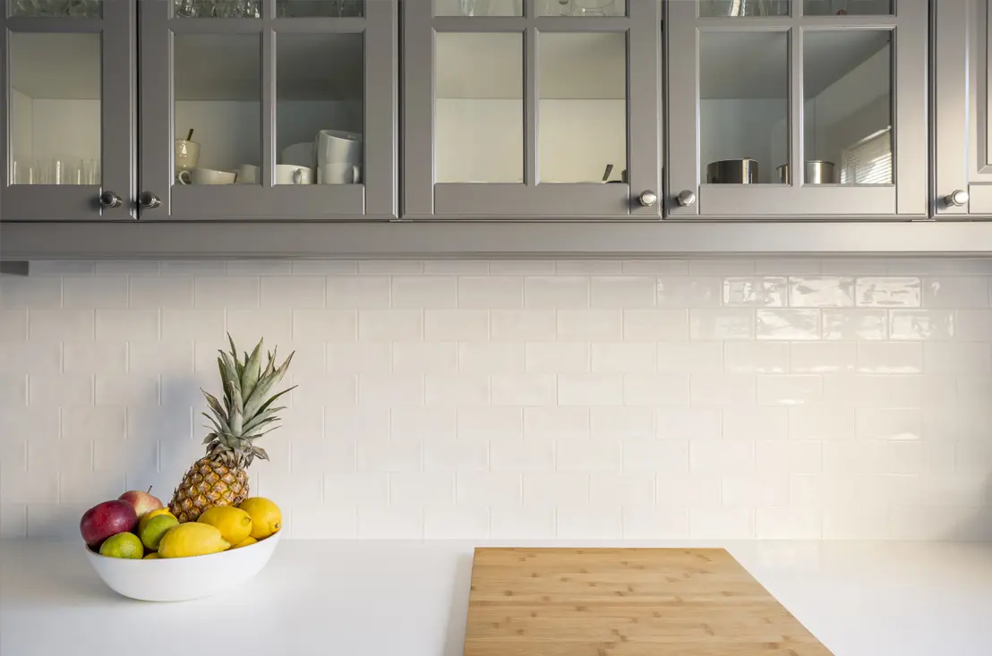 Before and after of renovated kitchen wall with tile paint in Kitchens